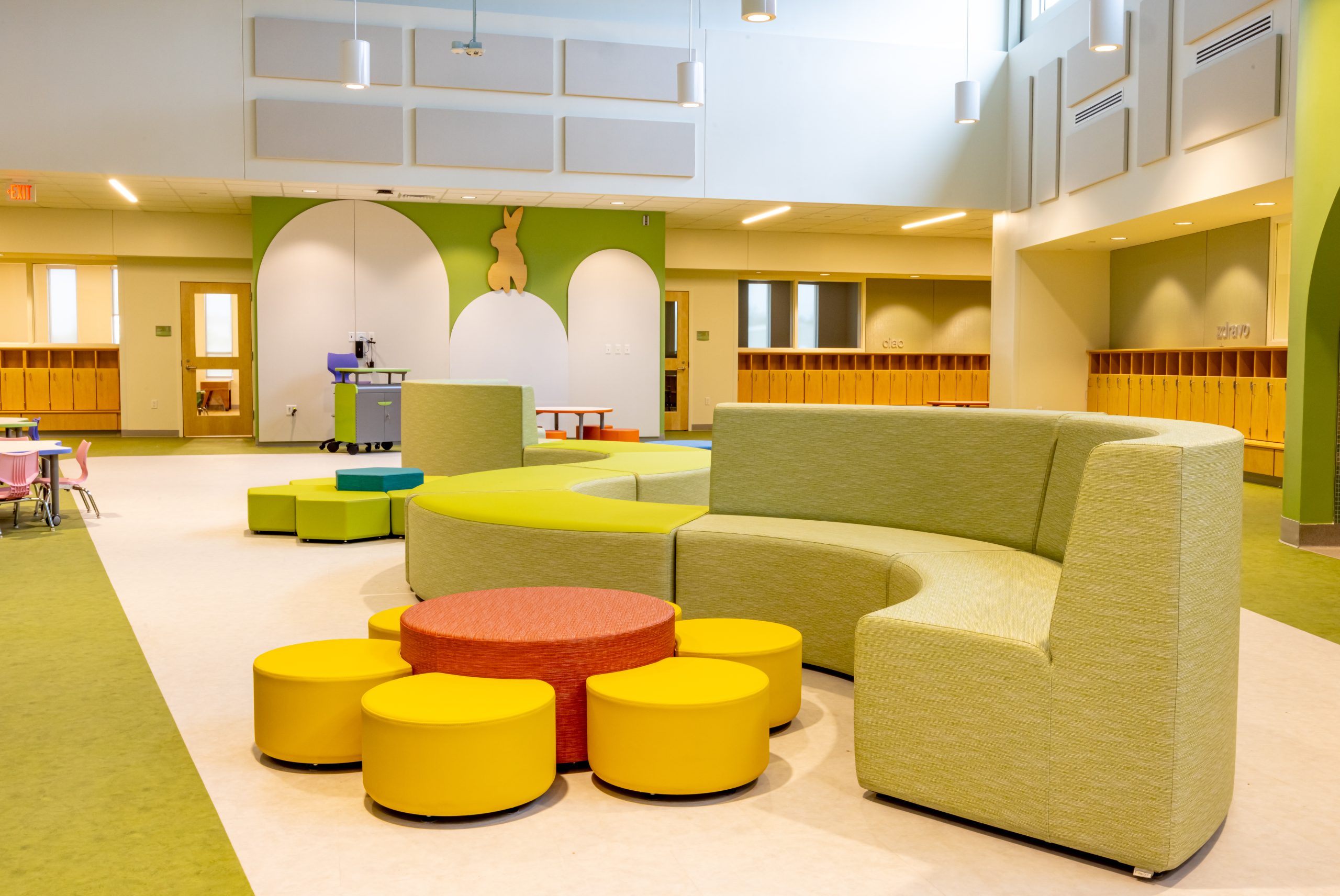 interior of a preschool play area with colorful modular furniture and small tables and chairs