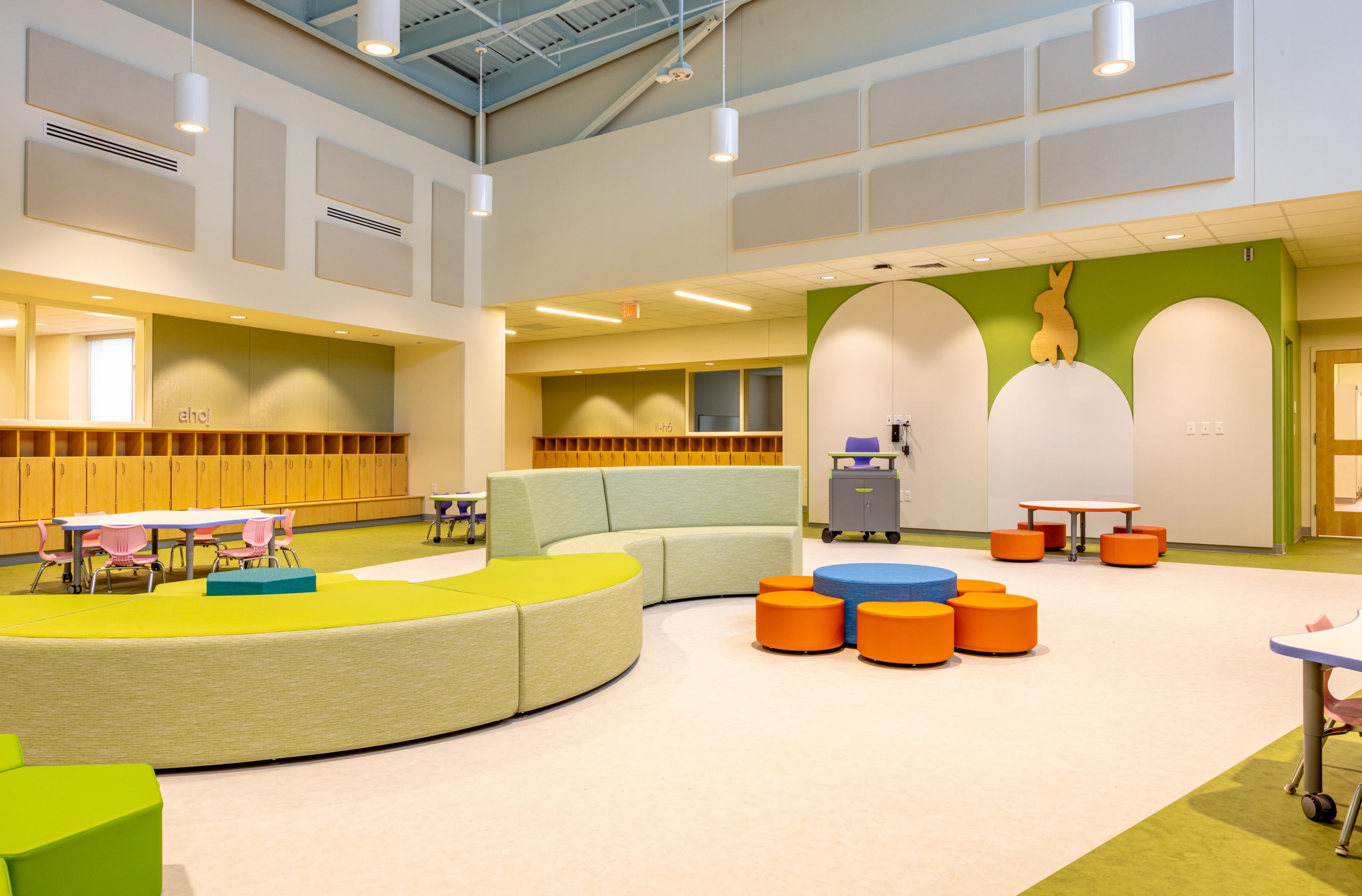 interior of a preschool play area with colorful modular furniture and small tables and chairs