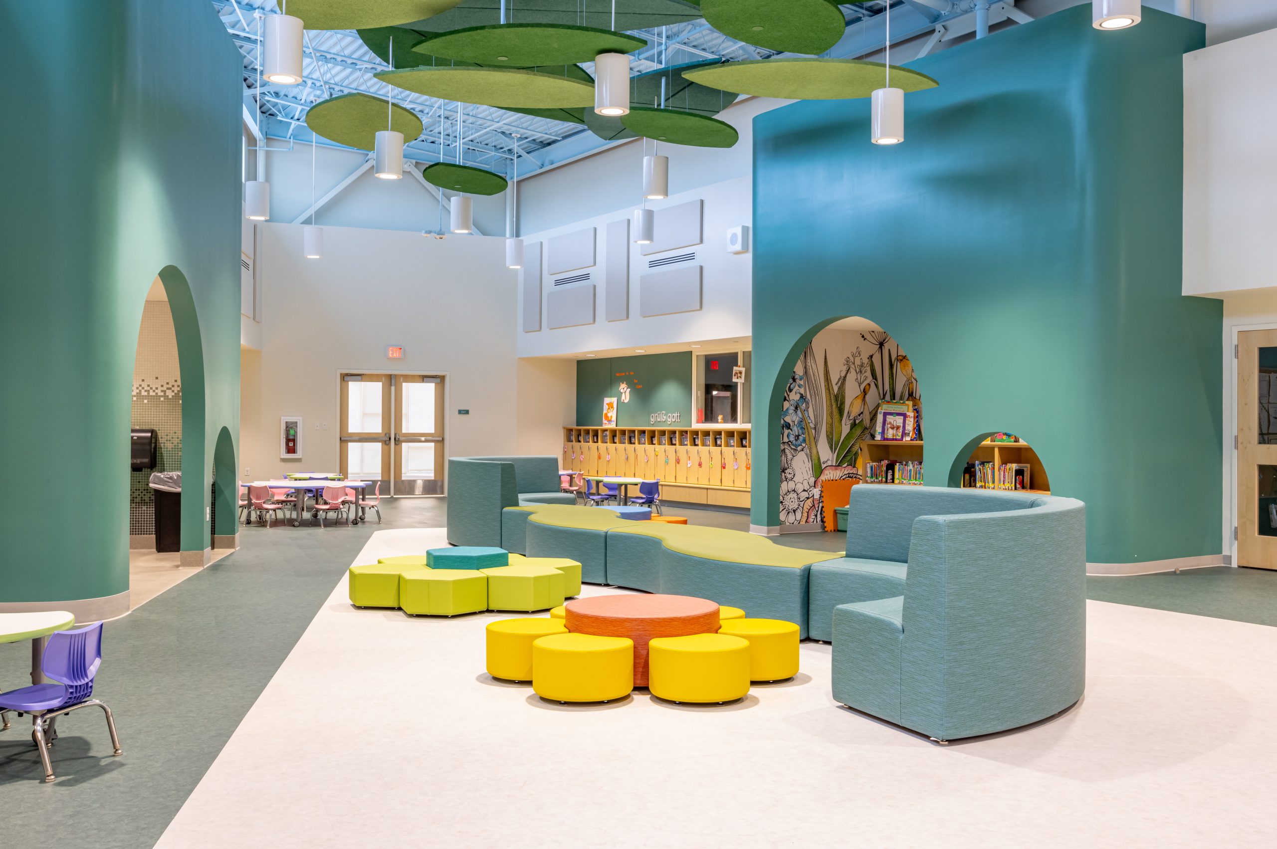 interior of a preschool play area with colorful modular furniture and small tables and chairs