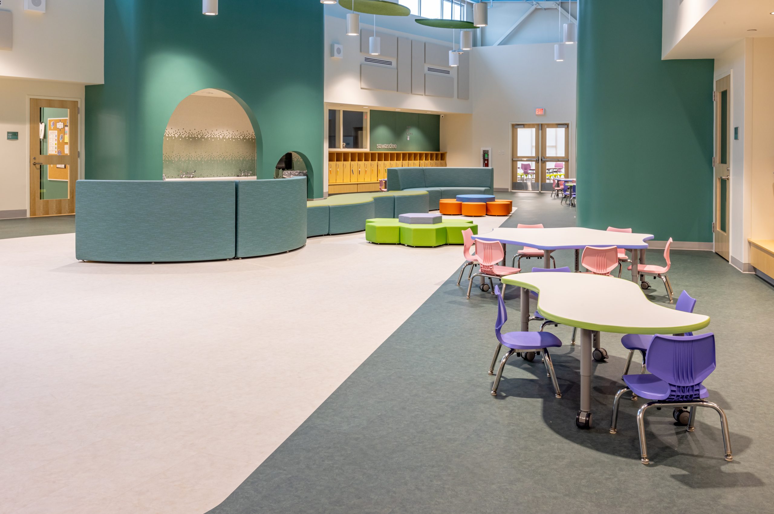 interior of a preschool play area with colorful modular furniture and small tables and chairs
